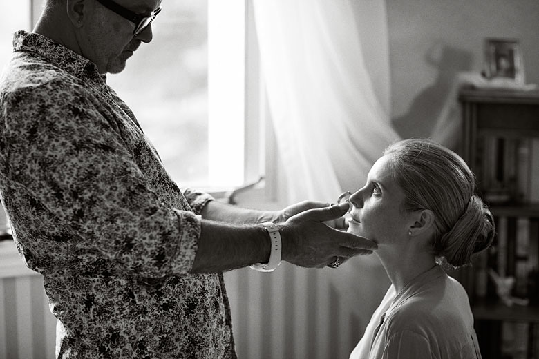 makeup artist working with a bride, wedding photography