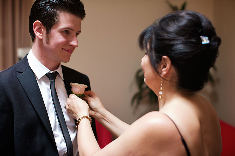 groom gets some help from a mother on the wedding day