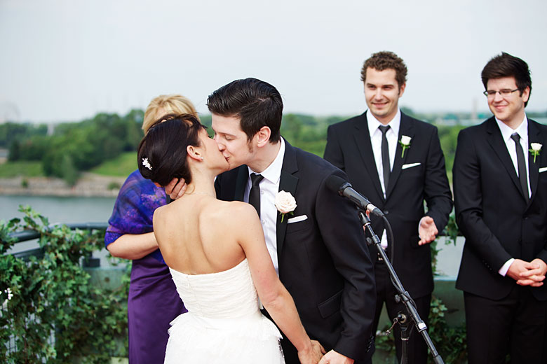 a first kiss of the bride and groom