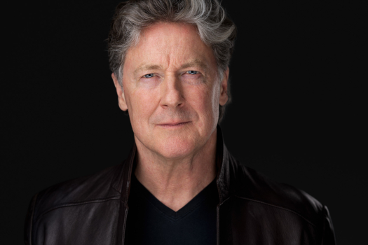 Actor headshot of John Allen Nelson wearing a dark leather jacket on a black studio background, photographed in Montreal by Vadim Daniel