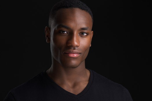 Professional modeling portfolio headshot of a Black man photographed by Montreal photographer Vadim Daniel