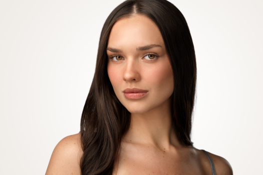 Modeling portfolio headshot of a woman with long dark hair on a light grey studio background by Montreal photographer Vadim Daniel