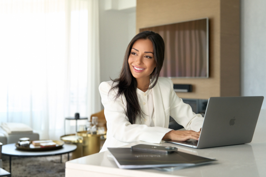 Personal branding portrait of a businesswoman working on a laptop, photographed on location in Montreal.