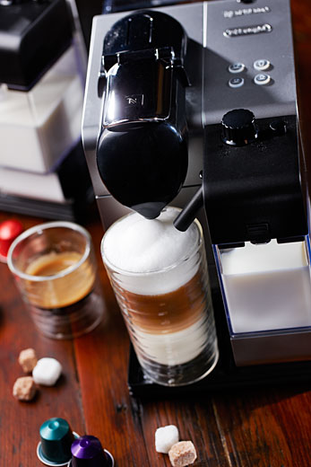 latte preparation with nespresso new machine, photography Vadim Daniel